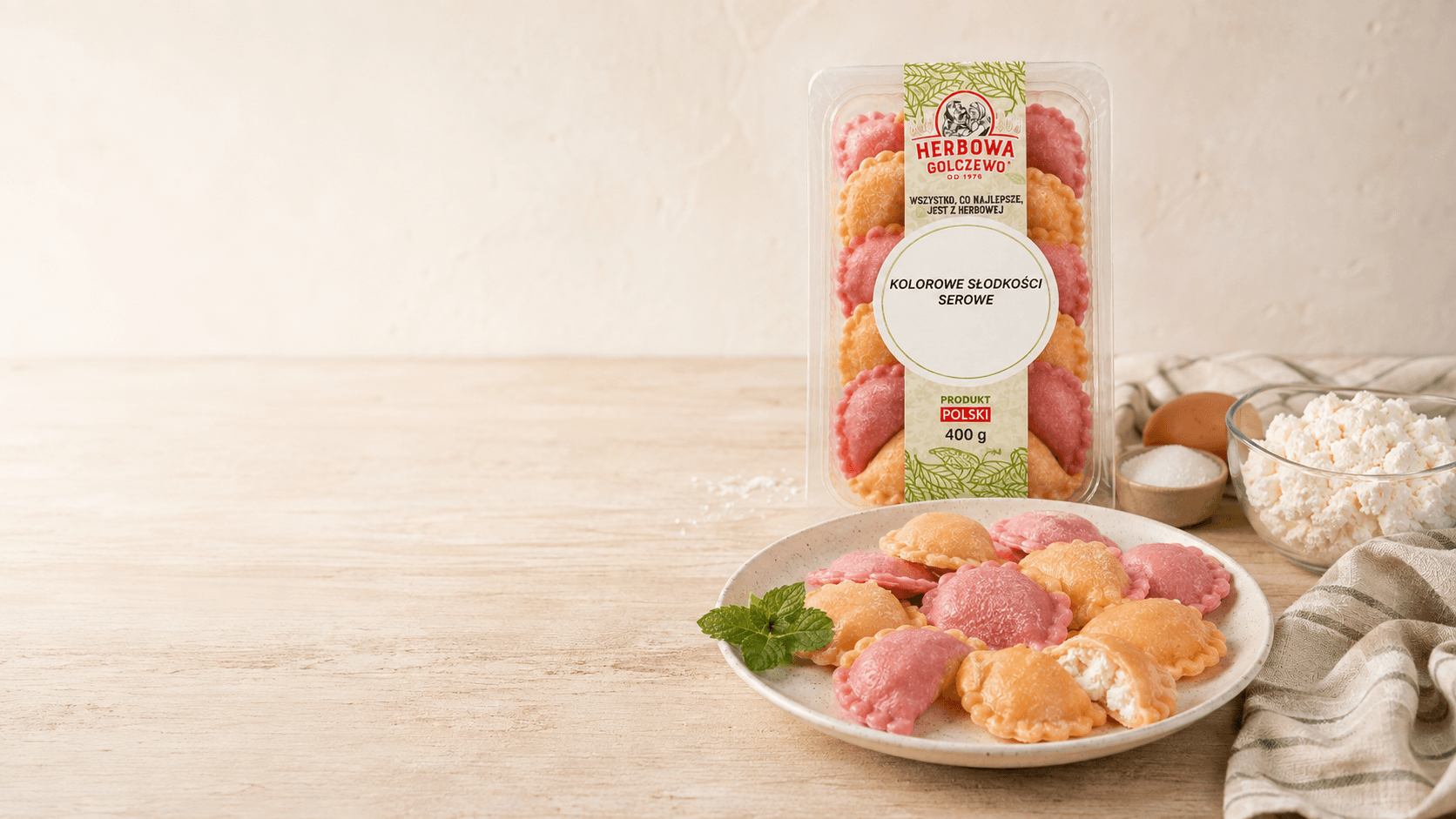 Kolorowe słodkości serowe Herbowa — wizualizacja tymczasowa podania i opakowania, przygotowana bez rzeczywistego zdjęcia produktu. Do zastąpienia po dostarczeniu fotografii.