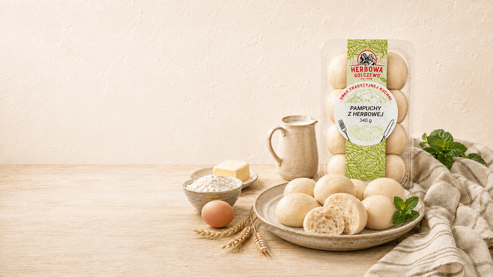 Pampuchy z Herbowej Herbowa — wizualizacja tymczasowa podania i opakowania, przygotowana bez rzeczywistego zdjęcia produktu. Do zastąpienia po dostarczeniu fotografii.
